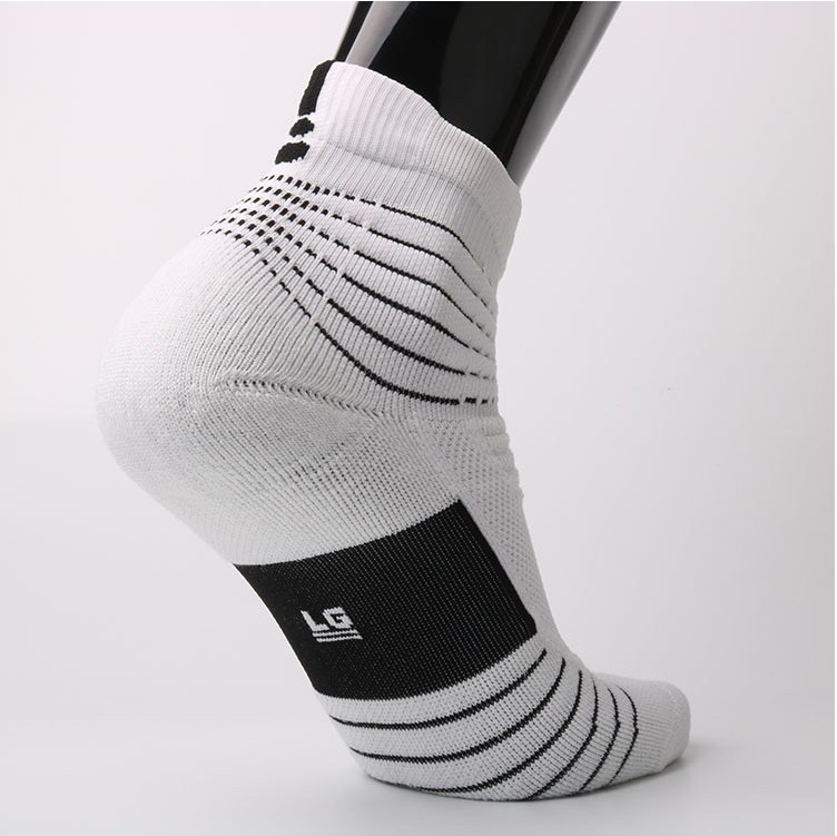 Grip sock on a foot form showing the silicone dot pattern on the sole