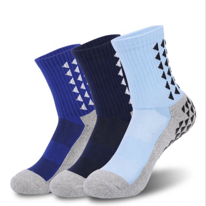 Three blue crew grip socks with black silicone grip pads on the heel and calf